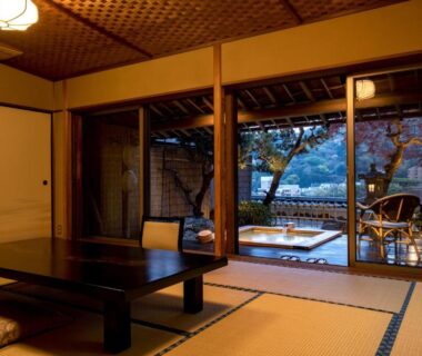 Tatami room with low table and shoji doors opening to veranda with wooden bath at Wakamatsu HakoneYugawara, Kanagawa