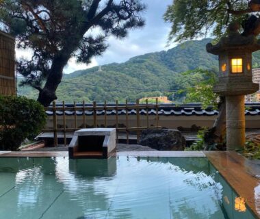 Outdoor onsen with wooden spout and stone lantern at Wakamatsu HakoneYugawara, Kanagawa, Kantō
