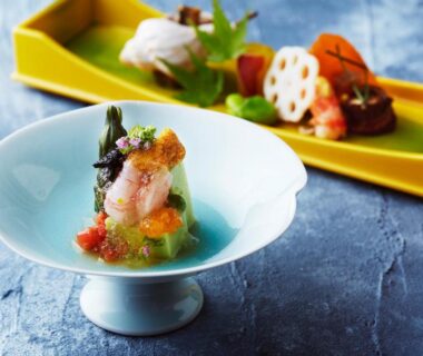 Delicate seafood and vegetable course in blue ceramic bowl at Wakamatsu Hot Spring Resort Hokkaidō