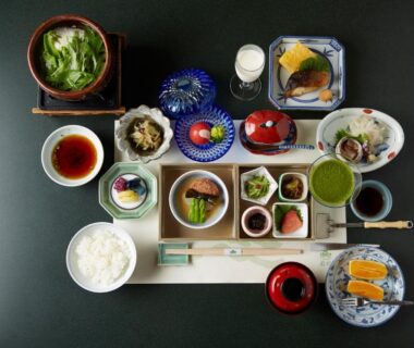 Assorted small dishes on tray with rice and tea at Wakamatsu Hot Spring Resort Hokkaidō Japan