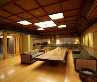 Spacious tatami lounge with low table and seating at Wakamatsu Hot Spring Resort in Hokkaidō, Japan