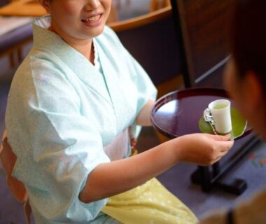 Staff in light kimono serving tea at Wakamatsuya ryokan in Yamagata