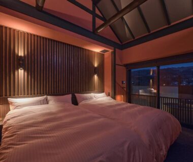 Double bed, exposed timber beams and balcony at Wakasa Annex in Nara