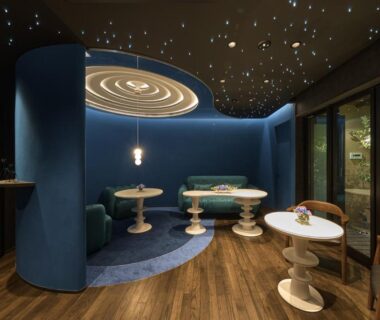 Curved blue seating alcove with round tables at Wakasa Annex in Nara, Kansai