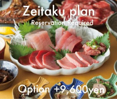 Assorted sashimi platter with small side dishes on table at Wakatake ryokan in Wakayama Japan