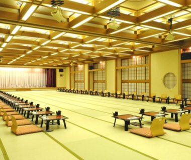Long tatami banquet room with low tables and cushions at Wakatake in Niigata, Chūbu, Japan