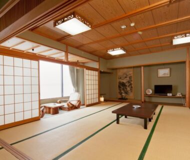 Spacious traditional tatami room with low table and shoji screens at Wakayama Kada Kaigetsu, Wakayama Japan