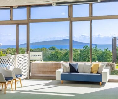 Glass-front lounge with sofa and sea view at Wan Wan Paradise Premier Izukogen, Shizuoka, Chūbu
