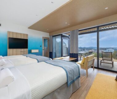 Twin beds with balcony and coastal view at Wan Wan Paradise Premier Nanki Shirahama, Wakayama