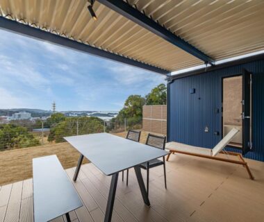 Covered wooden terrace with table and lounger at Wan Wan Paradise Premier Nanki Shirahama, Wakayama