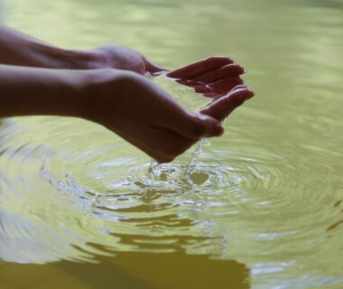 Hands cupping bath water at Wan Wan Paradise Premier Shiobara in Tochigi, Kantō