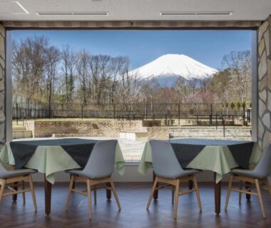 Dining area with tables and chairs facing Mount Fuji at Wan Wan Paradise in Yamanashi, Chūbu