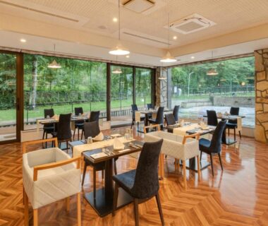 Spacious dining room with floor-to-ceiling windows and garden view at Wan Wan Paradise Premier Yamanakako Yamanashi