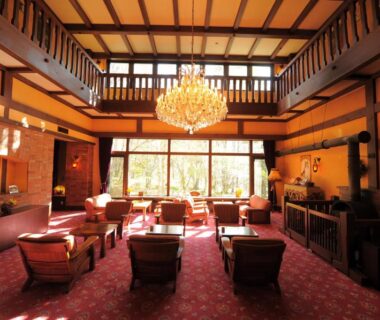 Spacious high ceiling lounge with chandelier and seating at Wan Wan Paradise Takayama Gifu Chūbu