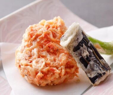 Mixed vegetable tempura fritter with eggplant and shishito pepper on ceramic plate at Wan Wan Paradise Takayama