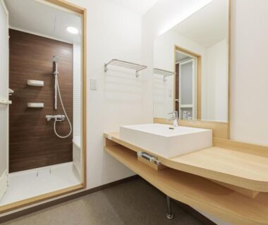 Bright bathroom with shower and wooden sink at Wan Wan Paradise Toba, Mie