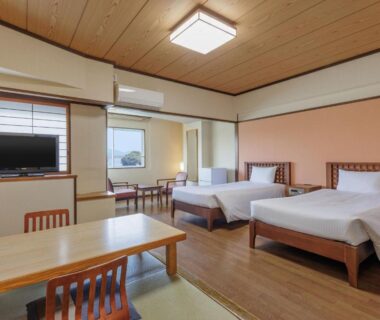 Spacious room with tatami area, twin beds and shoji screens at Wan Wan Paradise Toba Mie Kansai