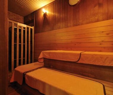 Wood-lined sauna benches with towels at Wataya Besso in Saga, Kyushu