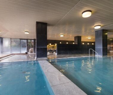 Spacious indoor bathing pool with pillars and windows at Wataya Besso Saga Kyushu Japan