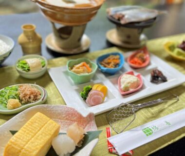 Table set with tamagoyaki, rice, miso soup and assorted small dishes at Watazen Ryokan, Kyoto