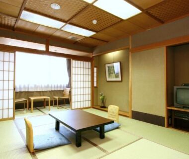 Traditional tatami room with low table, shoji screens and window seating at Watazen Ryokan, Kyoto