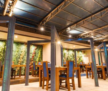 Wooden dining tables, green living wall, warm lighting at XYZ Private Spa and Seaside Resort, Wakayama