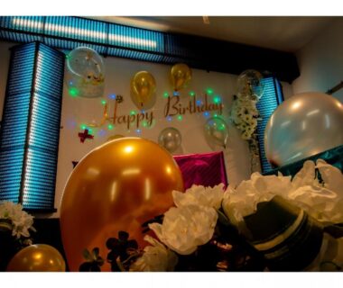 Festive balloons and floral decorations with a Happy Birthday banner in a ryokan guest room