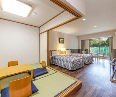 Tatami seating area and twin beds with balcony overlooking greenery at YU-FURI Izukogen, Shizuoka, Chūbu