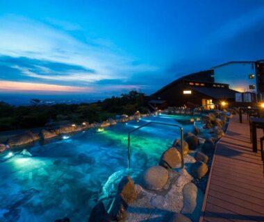 Illuminated outdoor onsen baths and wooden deck at dusk, YU-FURI Nasu-Takao Onsen Lodge, Tochigi