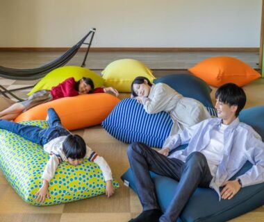 Group of guests relaxing on colorful beanbags on tatami floor at YU-FURI Nasu-Takao Onsen Lodge, Tochigi