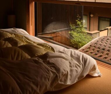 Soft-lit tatami room with futon beside wooden veranda overlooking inner courtyard at Yado Kiramachi Kyoto