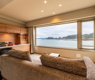 Two sofas facing a large bay window with coastal view at Yado Nakaya, Chiba, Kantō