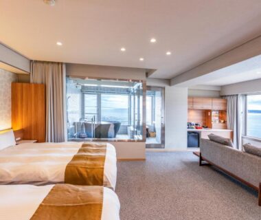 Spacious twin room with seating area, bathtub and sea view at Yado Nakaya in Chiba