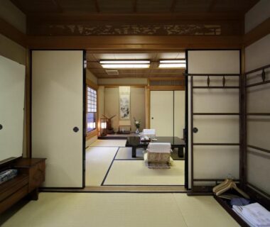 Tatami room with low table, shoji screens, and folded futon at Yadoya Kikokuso, Kyoto, Kansai