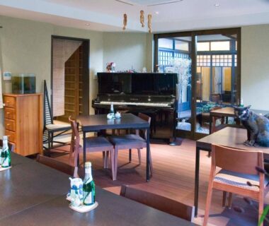 Dining area with piano and wooden furnishings at Yadoya Nishijinso in Kyoto Kansai