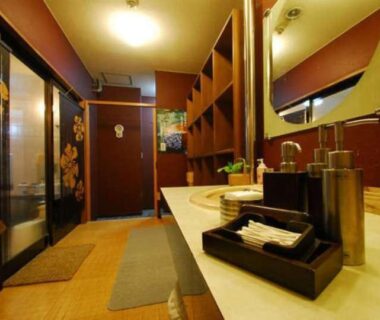 Sink counter and mirrors in a wash area with sliding floral doors at Yakushi no Yu, Gunma Kanto