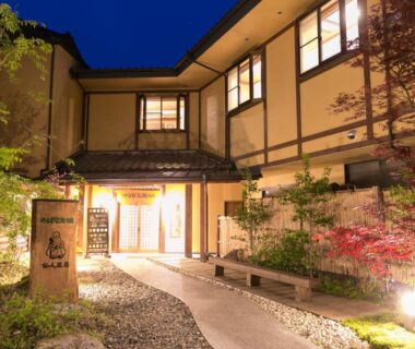 Lantern-lit ryokan entrance with stone path and shoji windows at Yamabiko Ryokan, Kumamoto, Kyūshū, Japan