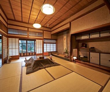 Tatami room with shoji screens, low table, wooden ceiling and garden view through sliding doors