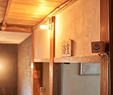 Warm wooden hallway with onsen sign at Yamada Bessou, Ōita, Kyūshū, Japan