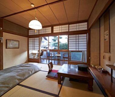 Traditional tatami room with low table, futon bedding and shoji screens at Yamada Bessou in Oita, Kyushu