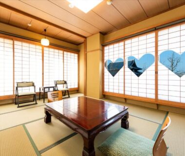 Tatami room with shoji screens and floor chairs at Yamadaya Ryokan Kyoto
