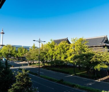 City view with Kyoto Tower, temple roofs and tree-lined street for Yamadaya Ryokan, Kyoto Kansai