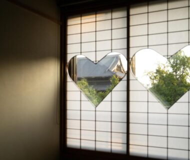 Traditional shoji screens with heart-shaped cutouts framing a garden view at Yamadaya Ryokan Kyoto