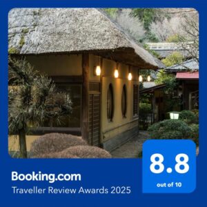Traditional thatched entrance with round windows and lanterns at Yamagaso, Kanagawa, Kantō, Japan