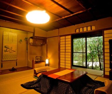 Traditional tatami room with low table, shoji screens and garden view at Yamagaso Kanagawa
