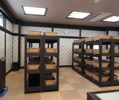 Indoor wooden shelving with wicker baskets for guest storage at Yamagisi Ryokan in Yamanashi, Chūbu