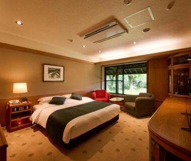Carpeted room with twin beds, seating area and garden view at Yamaha Resort Katsuragi Kitanomaru, Shizuoka