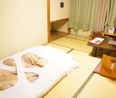 Traditional tatami room with folded futon and low table at Yamaichi ryokan in Iwate, Tōhoku