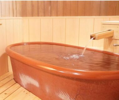 Ceramic soaking tub with wooden spout at Yamaichi, Iwate Tōhoku