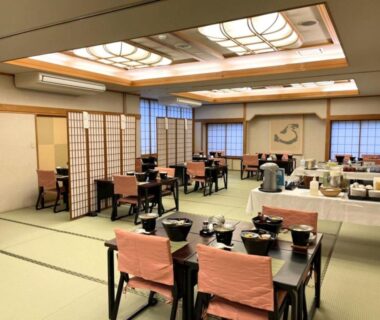 Tatami dining hall with low tables, shoji screens and service counter at Yamaichi in Iwate